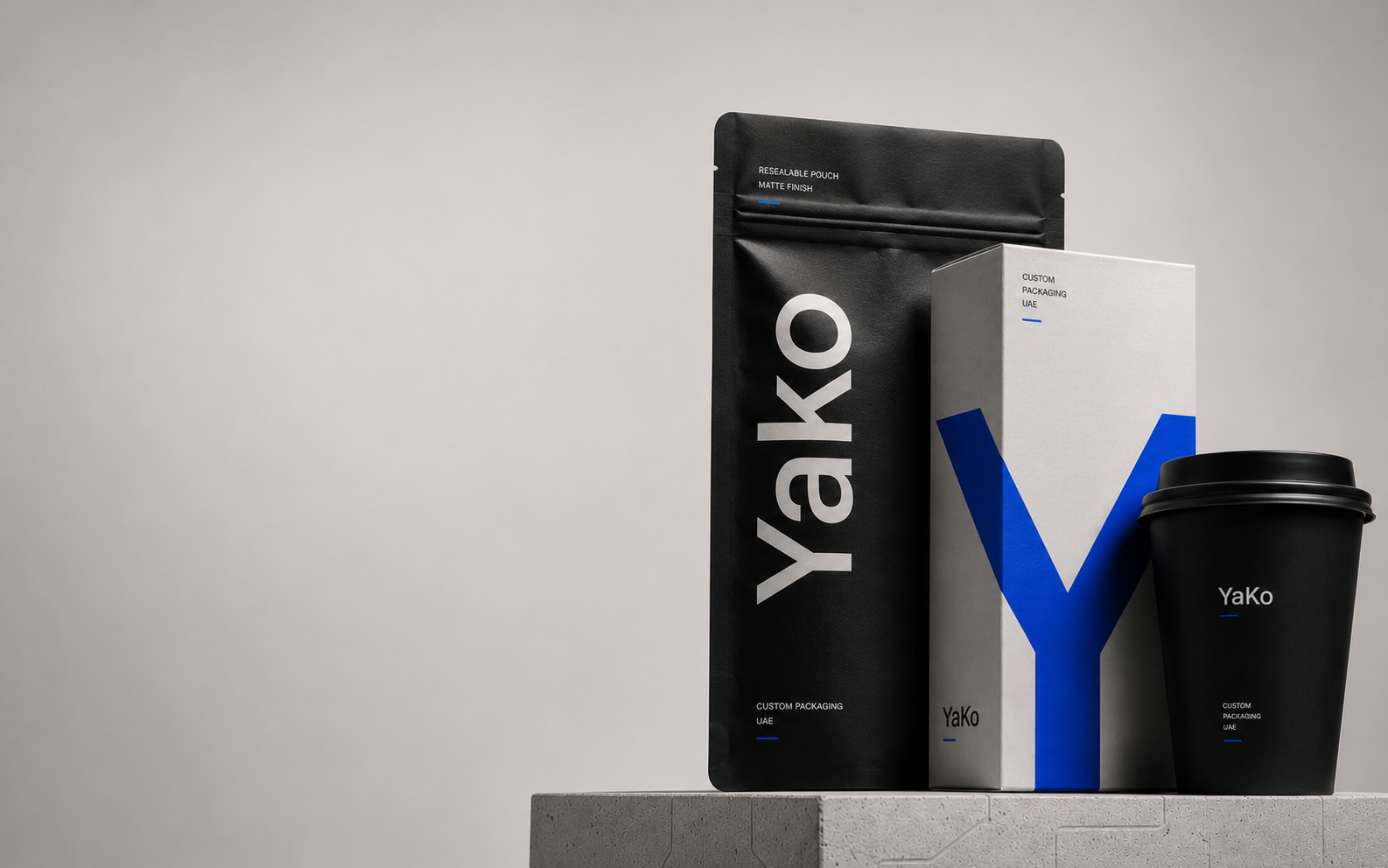 YaKo Packaging studio composition with a pouch, folding carton and coffee cup